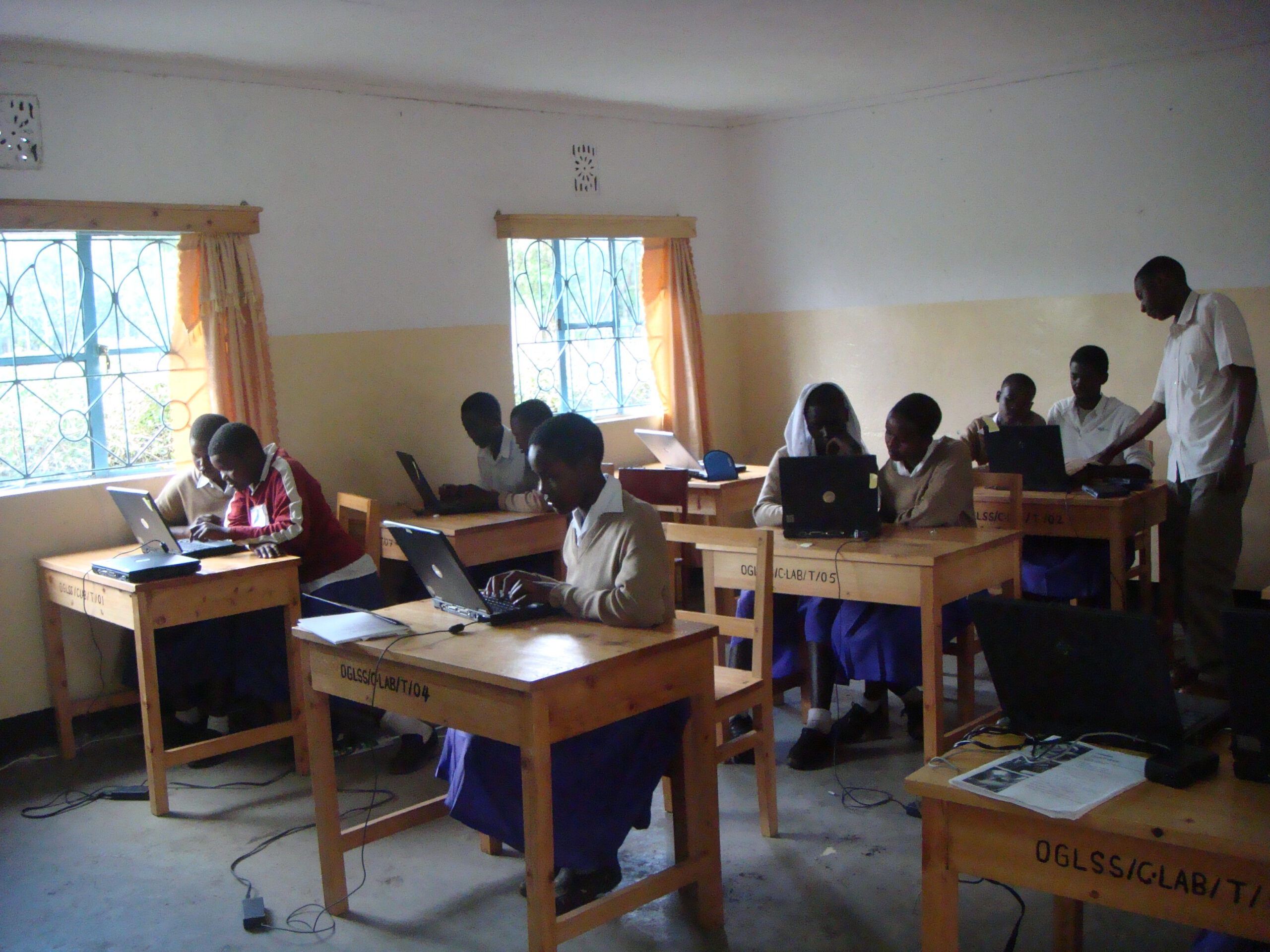 Tanzanian students using computers at their school desks
