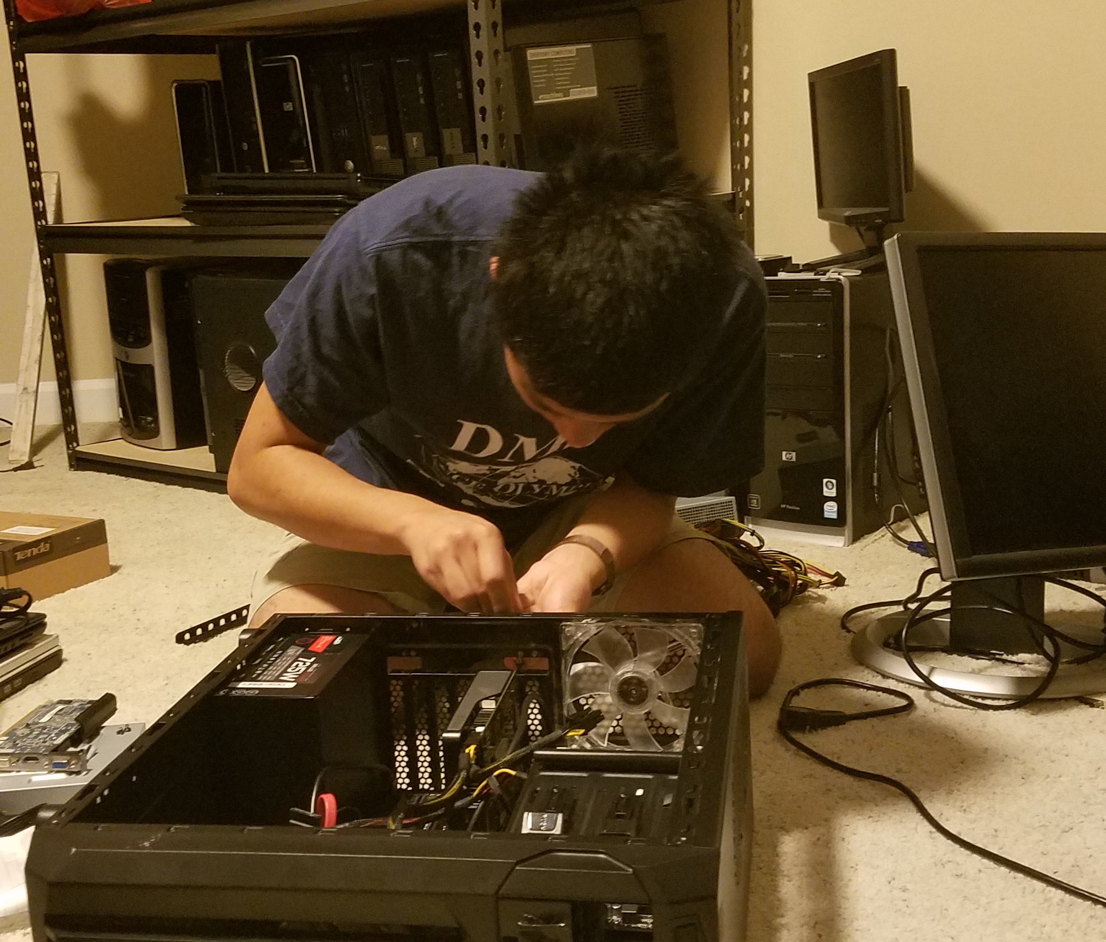 image of Howard Hua at work repairing a computer