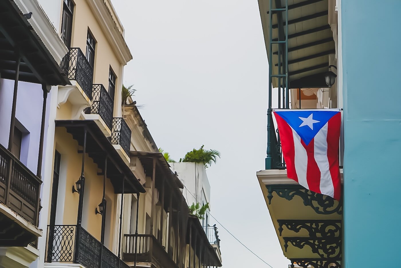 image of the puerto rican flag hanging outside of an apartment complex