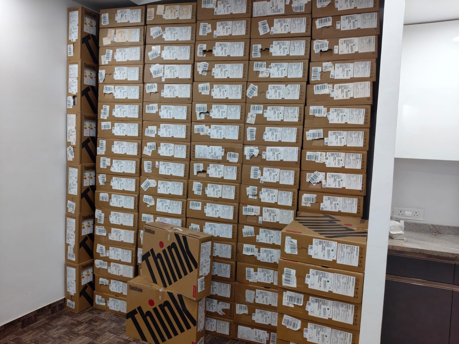 palette of donated laptops in their boxes